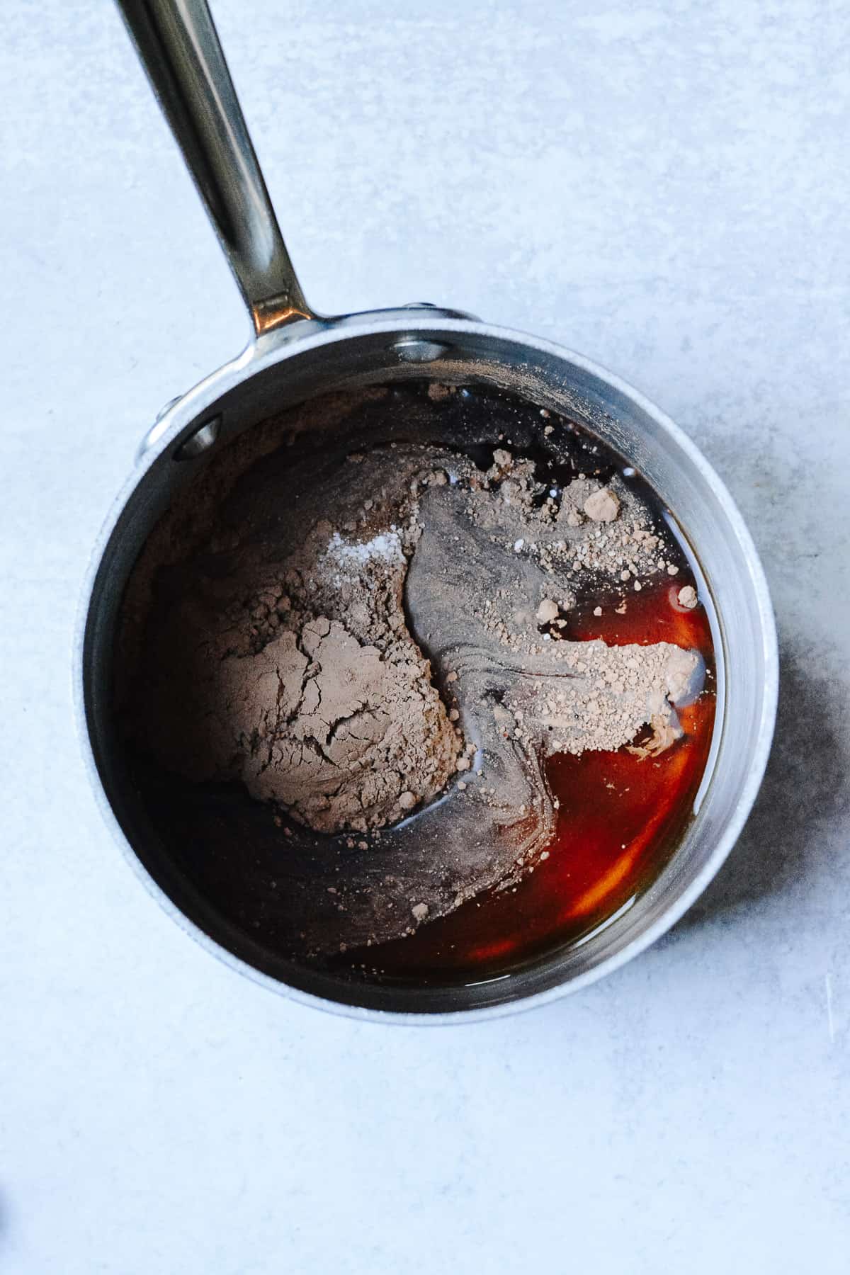 Sauce pan with cocoa powder, maple syrup and salt.