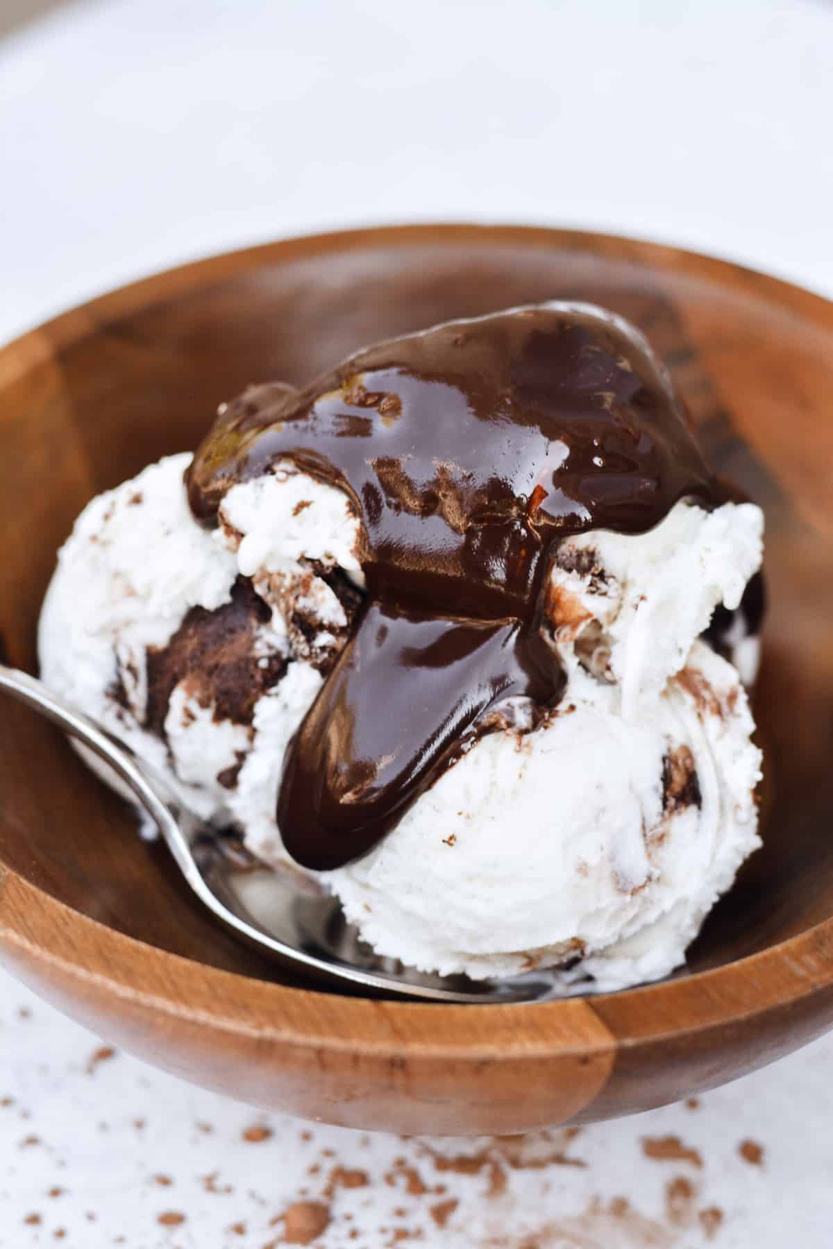 Hot fudge sauce dripping over ice cream.