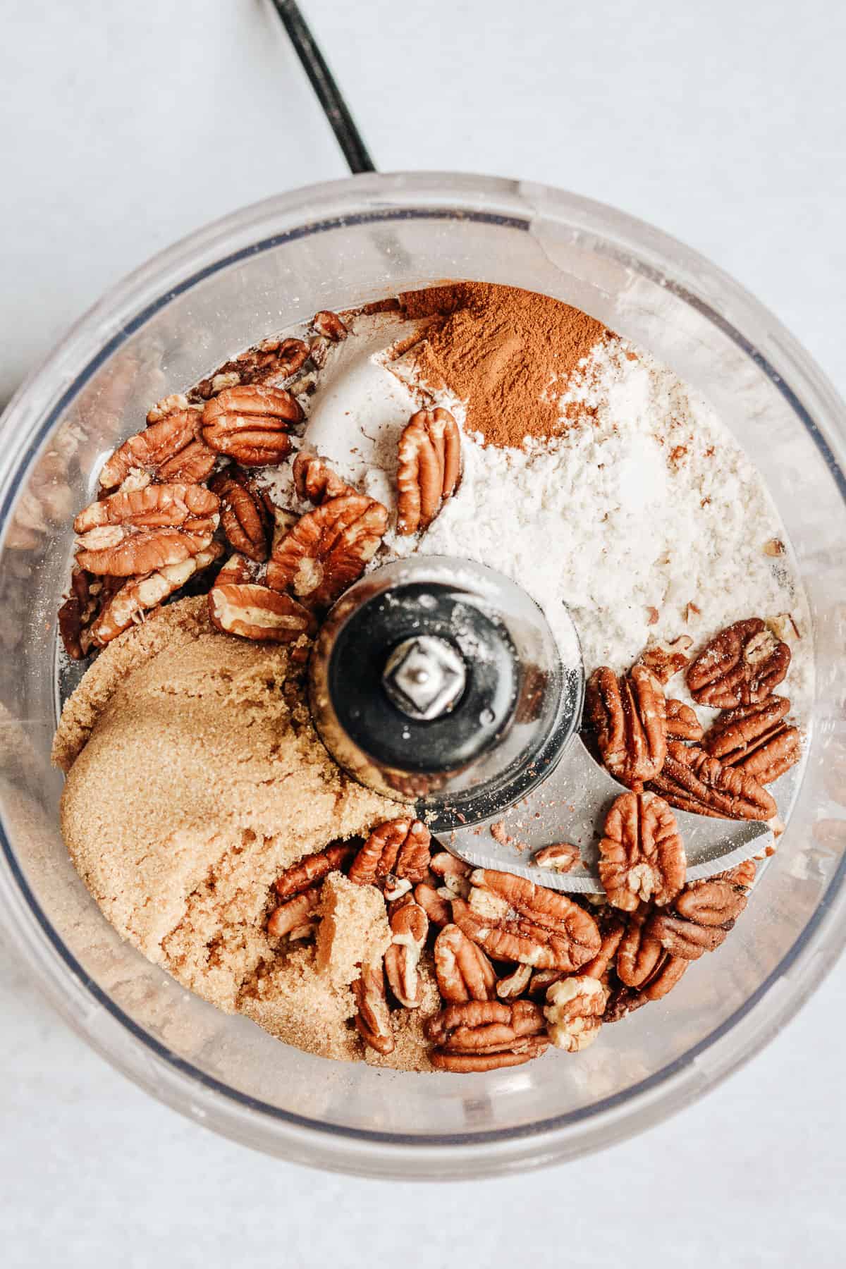 Pecans, brown sugar, flour and cinnamon in food processor for crumb topping.